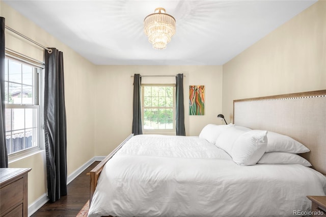 628 Cherry St, Denver, CO 80220 - bedroom with dark wood-style flooring, a chandelier, and baseboards