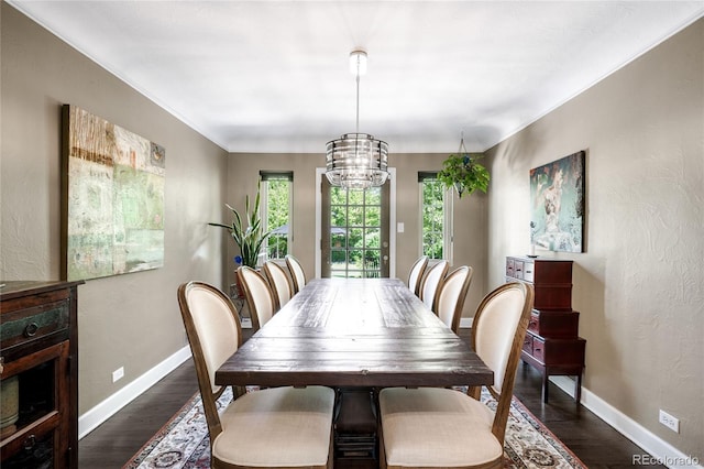 628 Cherry St, Denver, CO 80220 - dining area featuring a chandelier, baseboards, dark wood-type flooring, and crown molding