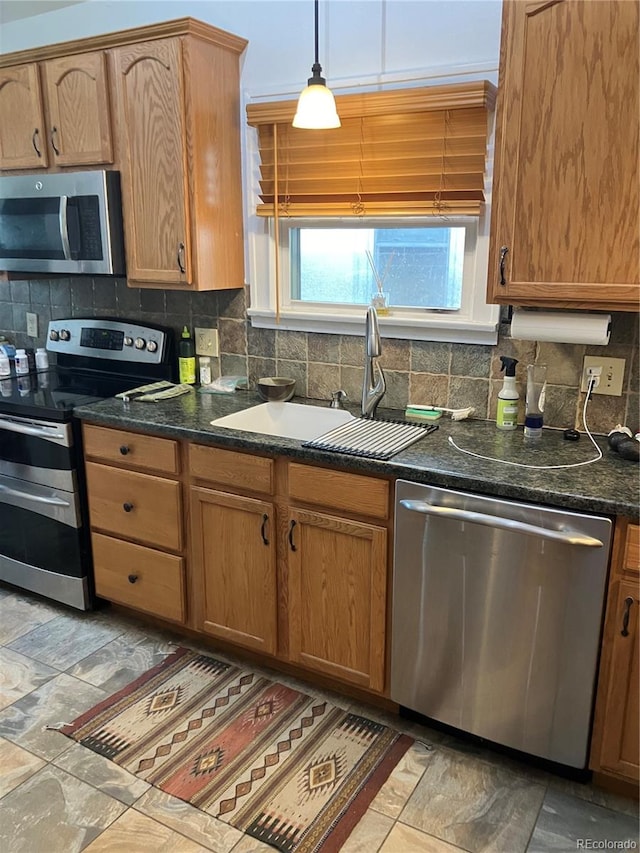 kitchen with sink, tile flooring, backsplash, and stainless steel appliances