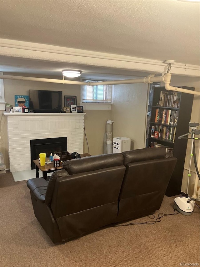 living room featuring a textured ceiling, a fireplace, and carpet floors