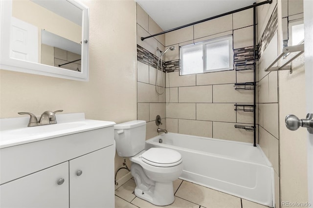 full bathroom featuring tile patterned flooring, vanity, tiled shower / bath combo, and toilet