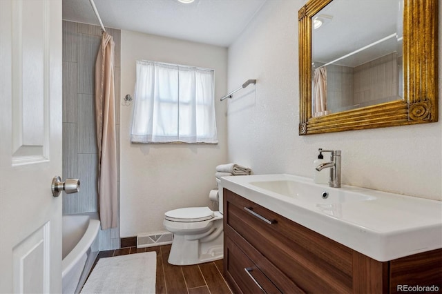 full bathroom featuring vanity, toilet, wood-type flooring, and shower / bath combo