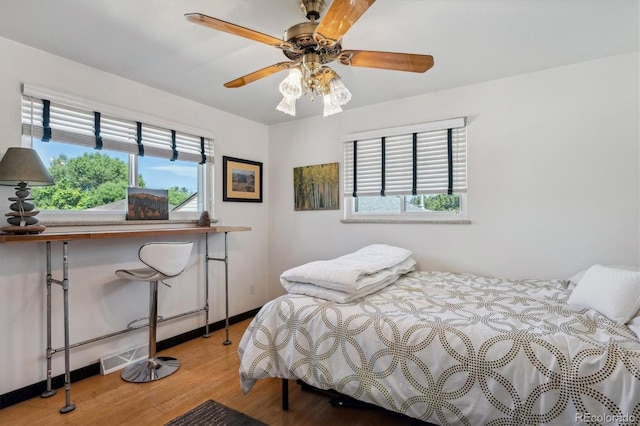 bedroom with light wood-type flooring and ceiling fan