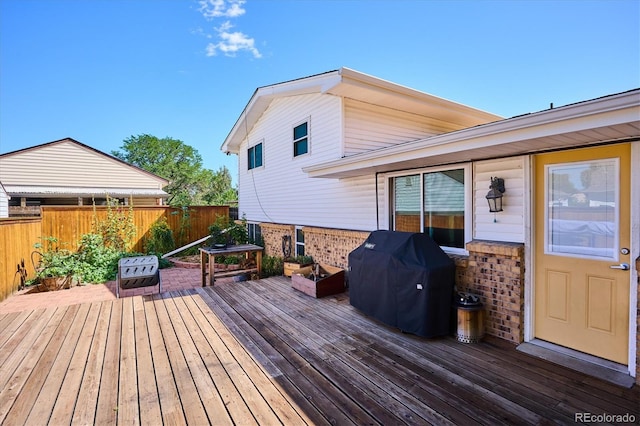 wooden deck featuring area for grilling