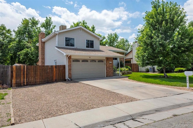 traditional-style house featuring brick siding, a front lawn, fence, concrete driveway, and an attached garage