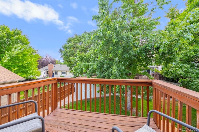 wooden terrace featuring a fenced backyard and a yard