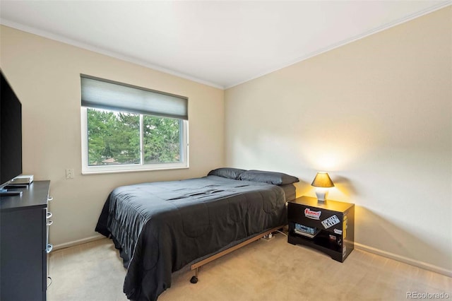 bedroom featuring light colored carpet, baseboards, and ornamental molding