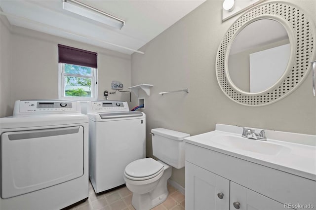 bathroom featuring vanity, toilet, and washing machine and dryer