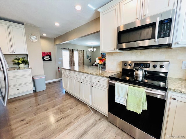 kitchen with stainless steel appliances and white cabinetry