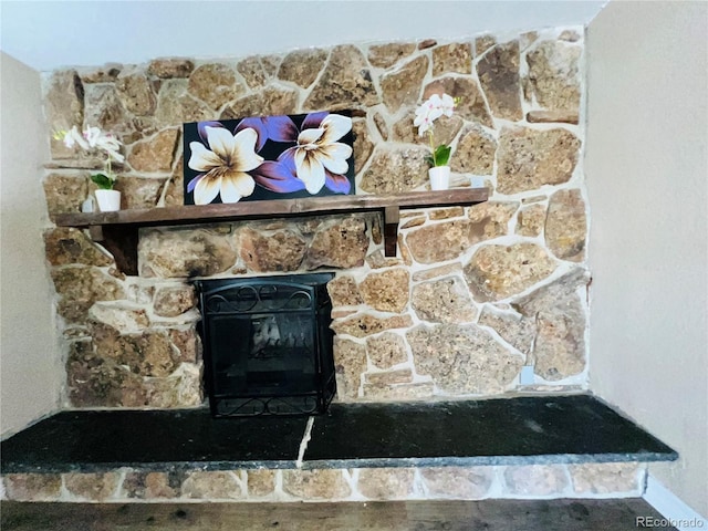 details with a stone fireplace