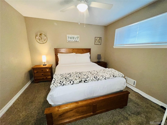 bedroom with ceiling fan and dark carpet