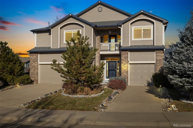 view of front of home featuring a balcony and a garage