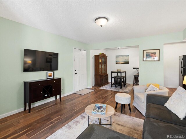 living area with wood finished floors and baseboards