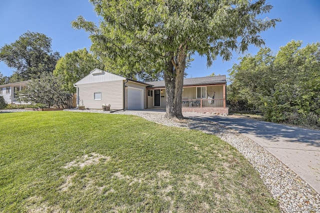 view of front of home with a garage, covered porch, and a front lawn