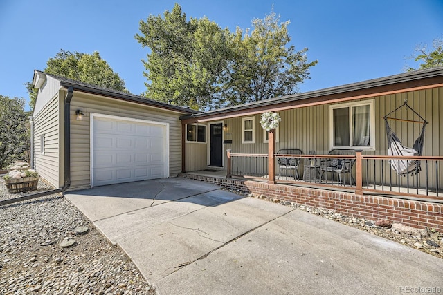 ranch-style home with covered porch and a garage