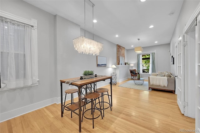 dining area with a chandelier and light wood-type flooring