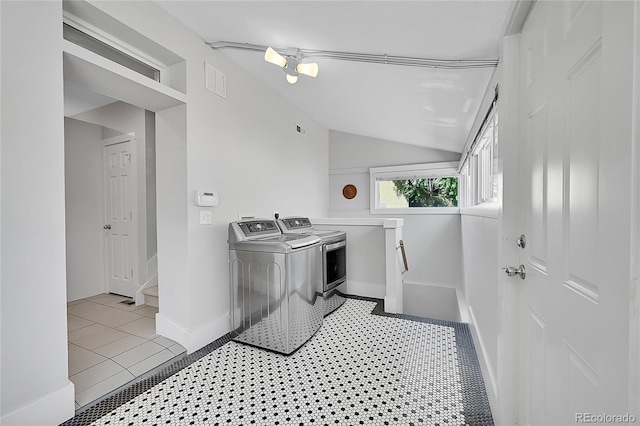 clothes washing area featuring separate washer and dryer and light tile patterned floors