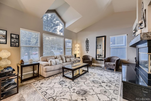 living room with high vaulted ceiling and a healthy amount of sunlight