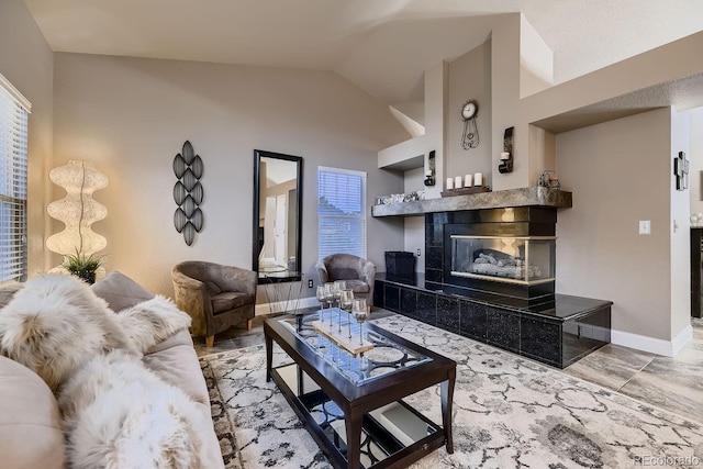 living room with a fireplace and lofted ceiling