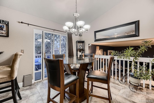 dining room with a chandelier and vaulted ceiling