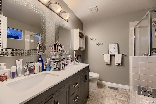 bathroom with vanity, tile patterned flooring, toilet, walk in shower, and a textured ceiling