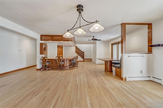 kitchen with pendant lighting, ceiling fan, and light hardwood / wood-style floors