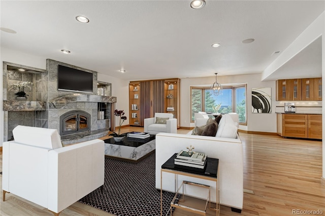 living room with a fireplace and light hardwood / wood-style flooring