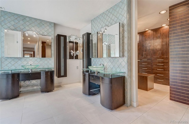 bathroom with tile patterned flooring, backsplash, and sink