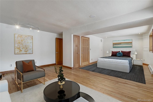 bedroom featuring a textured ceiling and hardwood / wood-style flooring