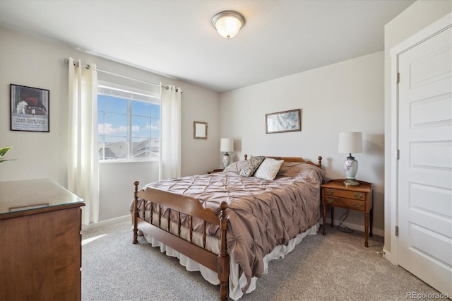 bedroom featuring light carpet and baseboards