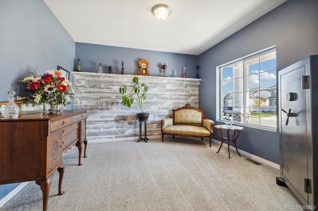 sitting room with baseboards, visible vents, and carpet