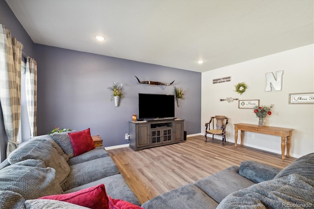 living room with wood finished floors, baseboards, and recessed lighting
