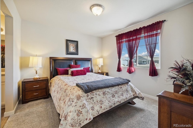 bedroom with baseboards and carpet
