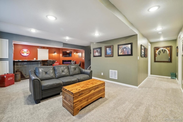 carpeted living area featuring a dry bar, recessed lighting, and visible vents