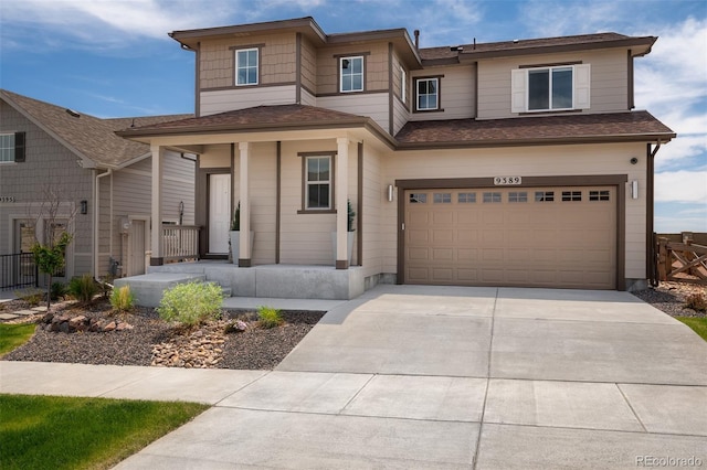 9389 Mayflower Gulch Way, Colorado Springs, CO 80927 - view of front of home featuring a garage, covered porch, driveway, and roof with shingles
