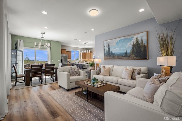 9389 Mayflower Gulch Way, Colorado Springs, CO 80927 - living area with a chandelier, light wood finished floors, and recessed lighting