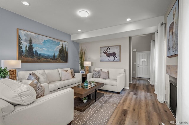 9389 Mayflower Gulch Way, Colorado Springs, CO 80927 - living room featuring wood finished floors, recessed lighting, a fireplace, and baseboards