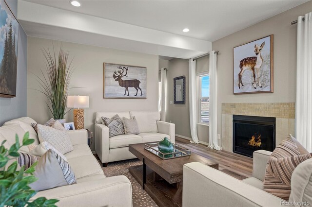 9389 Mayflower Gulch Way, Colorado Springs, CO 80927 - living room featuring wood finished floors, a fireplace, recessed lighting, and baseboards