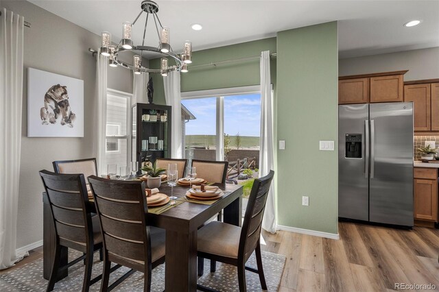 9389 Mayflower Gulch Way, Colorado Springs, CO 80927 - dining area with light wood-style floors, a chandelier, baseboards, and recessed lighting