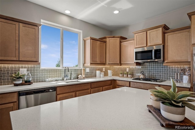 9389 Mayflower Gulch Way, Colorado Springs, CO 80927 - kitchen with stainless steel appliances, light countertops, backsplash, a sink, and recessed lighting