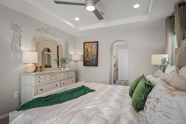 9389 Mayflower Gulch Way, Colorado Springs, CO 80927 - bedroom with arched walkways, a raised ceiling, recessed lighting, and ceiling fan