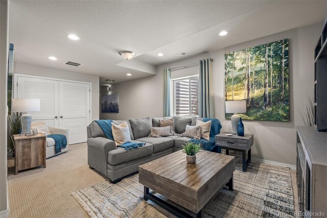 9389 Mayflower Gulch Way, Colorado Springs, CO 80927 - living room with a textured ceiling, recessed lighting, light colored carpet, and baseboards