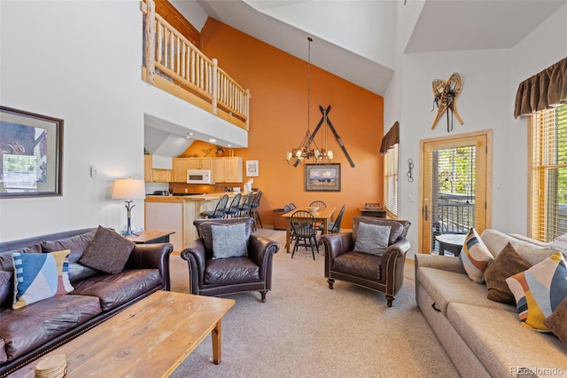 33 Broken Lance Dr Unit 207S, Breckenridge, CO 80424 - living area featuring light colored carpet, a towering ceiling, and a chandelier
