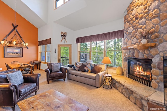 33 Broken Lance Dr Unit 207S, Breckenridge, CO 80424 - living room with carpet flooring, a chandelier, a stone fireplace, and a high ceiling