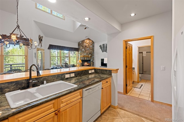 33 Broken Lance Dr Unit 207S, Breckenridge, CO 80424 - kitchen featuring dishwasher, open floor plan, light tile patterned floors, light carpet, and a stone fireplace