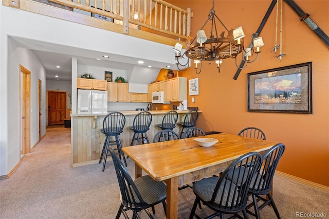 33 Broken Lance Dr Unit 207S, Breckenridge, CO 80424 - dining area with light carpet, a towering ceiling, a chandelier, and recessed lighting