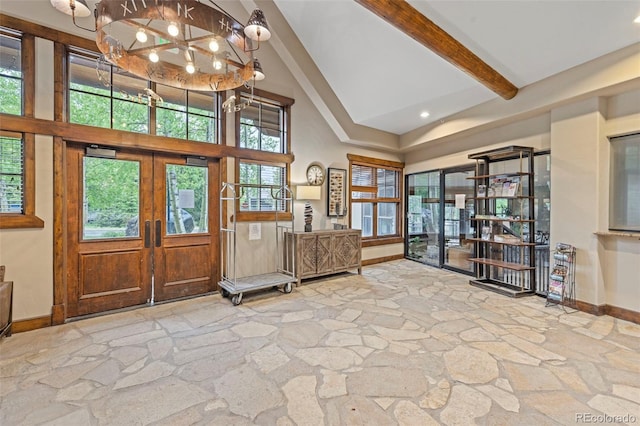 33 Broken Lance Dr Unit 207S, Breckenridge, CO 80424 - entryway with stone flooring, high vaulted ceiling, a chandelier, beamed ceiling, and french doors
