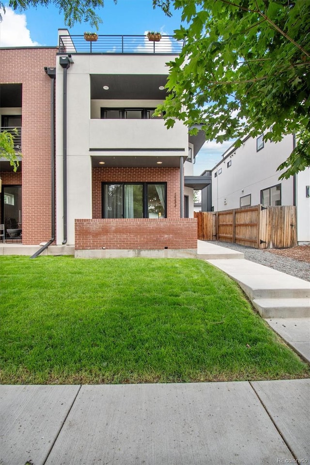 2244 S Lincoln St, Denver, CO 80210 - view of front facade featuring brick siding, stucco siding, and a balcony