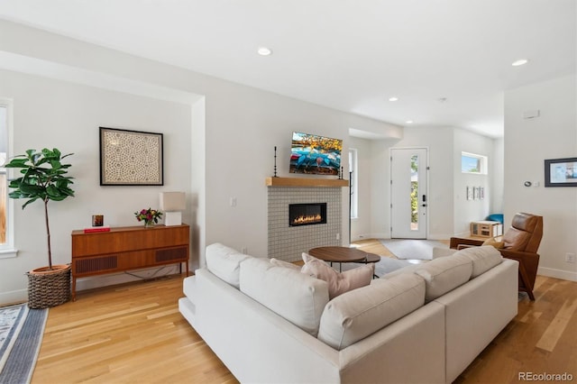 2244 S Lincoln St, Denver, CO 80210 - living room with a fireplace, light wood finished floors, recessed lighting, and baseboards