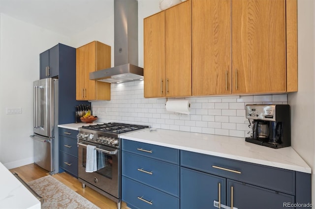 2244 S Lincoln St, Denver, CO 80210 - kitchen with appliances with stainless steel finishes, island exhaust hood, light wood-type flooring, and blue cabinets